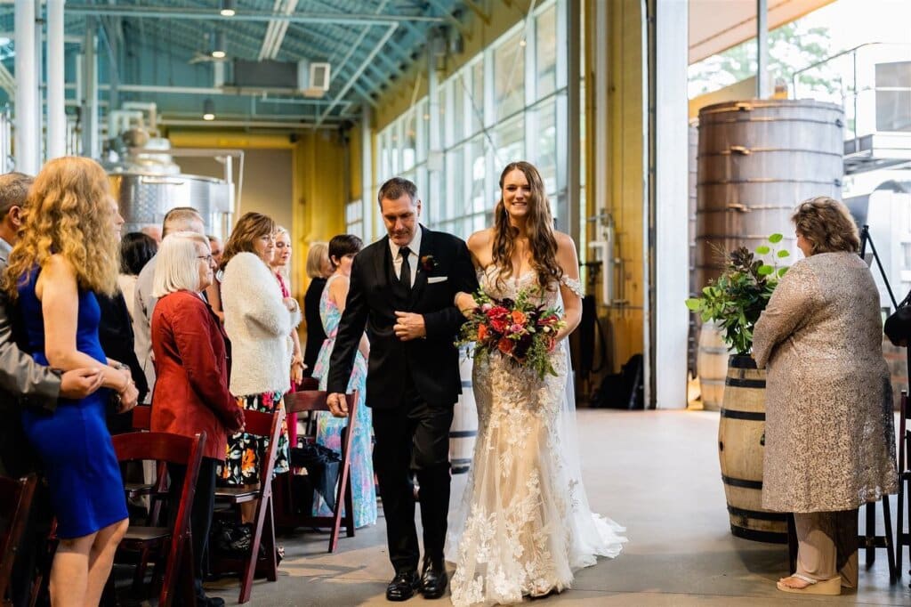 Bride walking down the aisle with her dad at Newport Vineyards
