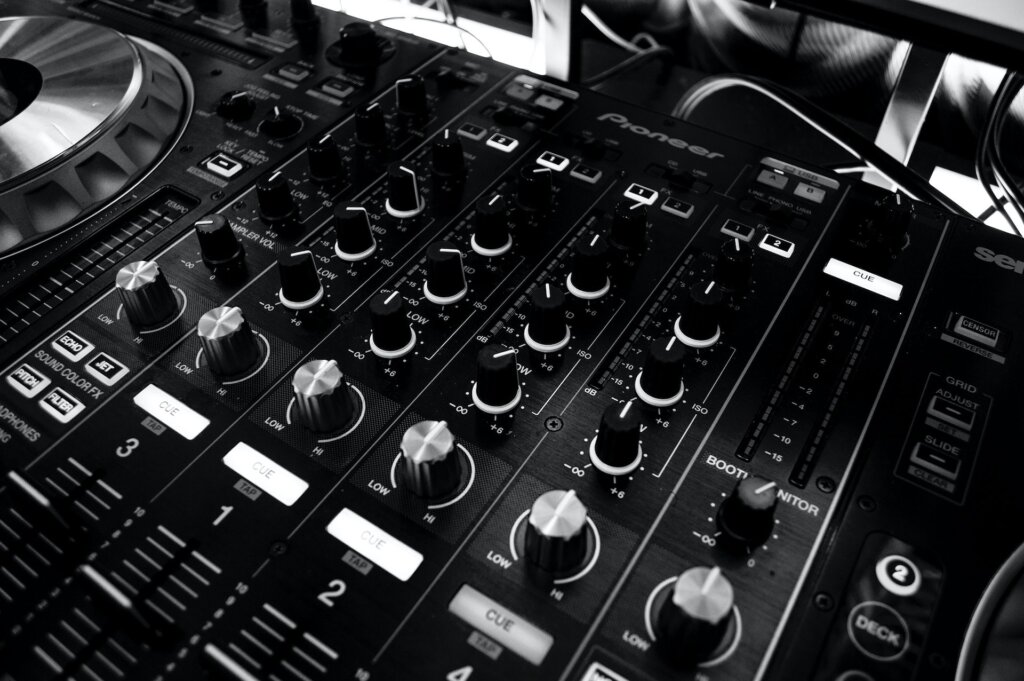 Black and White photo of a DJ Mixing Board